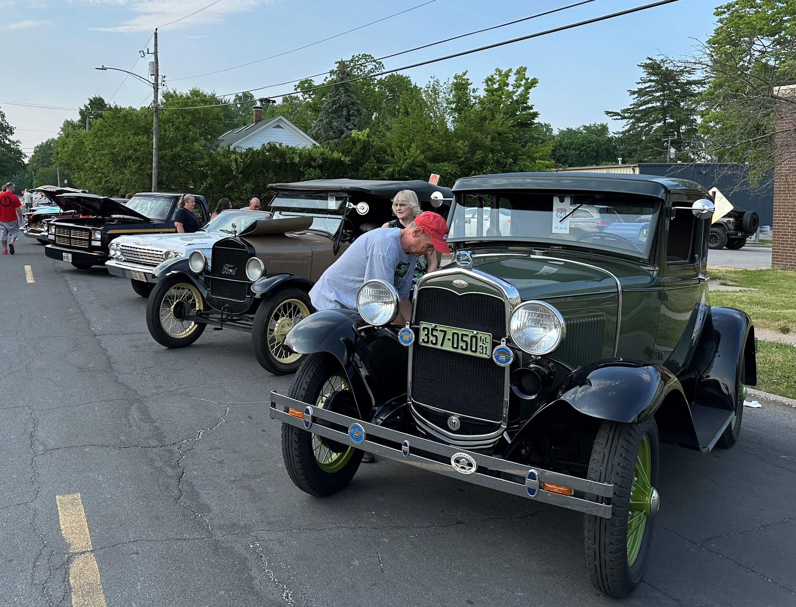 Visitors check out a line of classic cars displayed at the Route 66 Festival