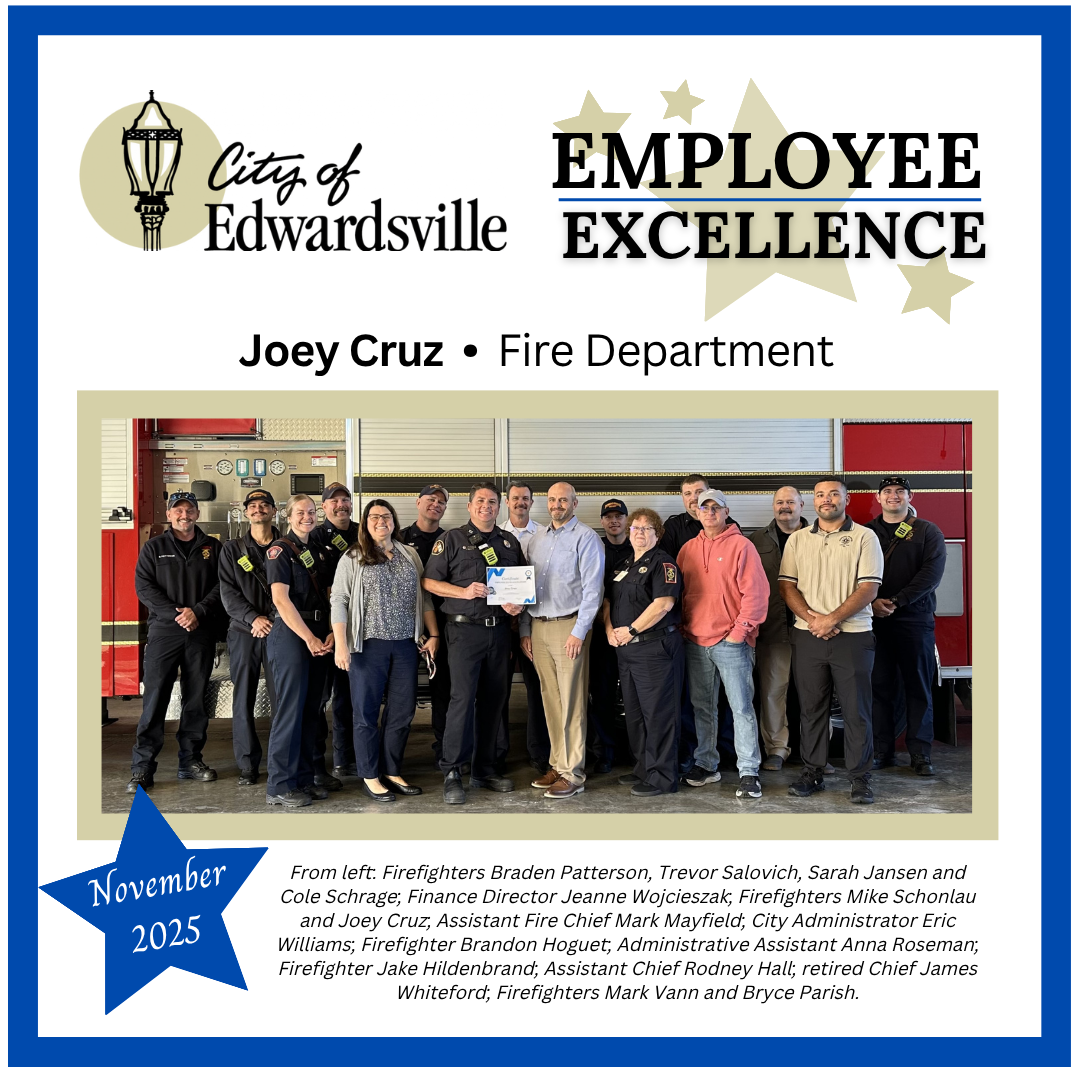 A group of people pose for a photo in front of a firetruck